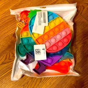 Unopened 4-pack of rainbow pop fidget toys
